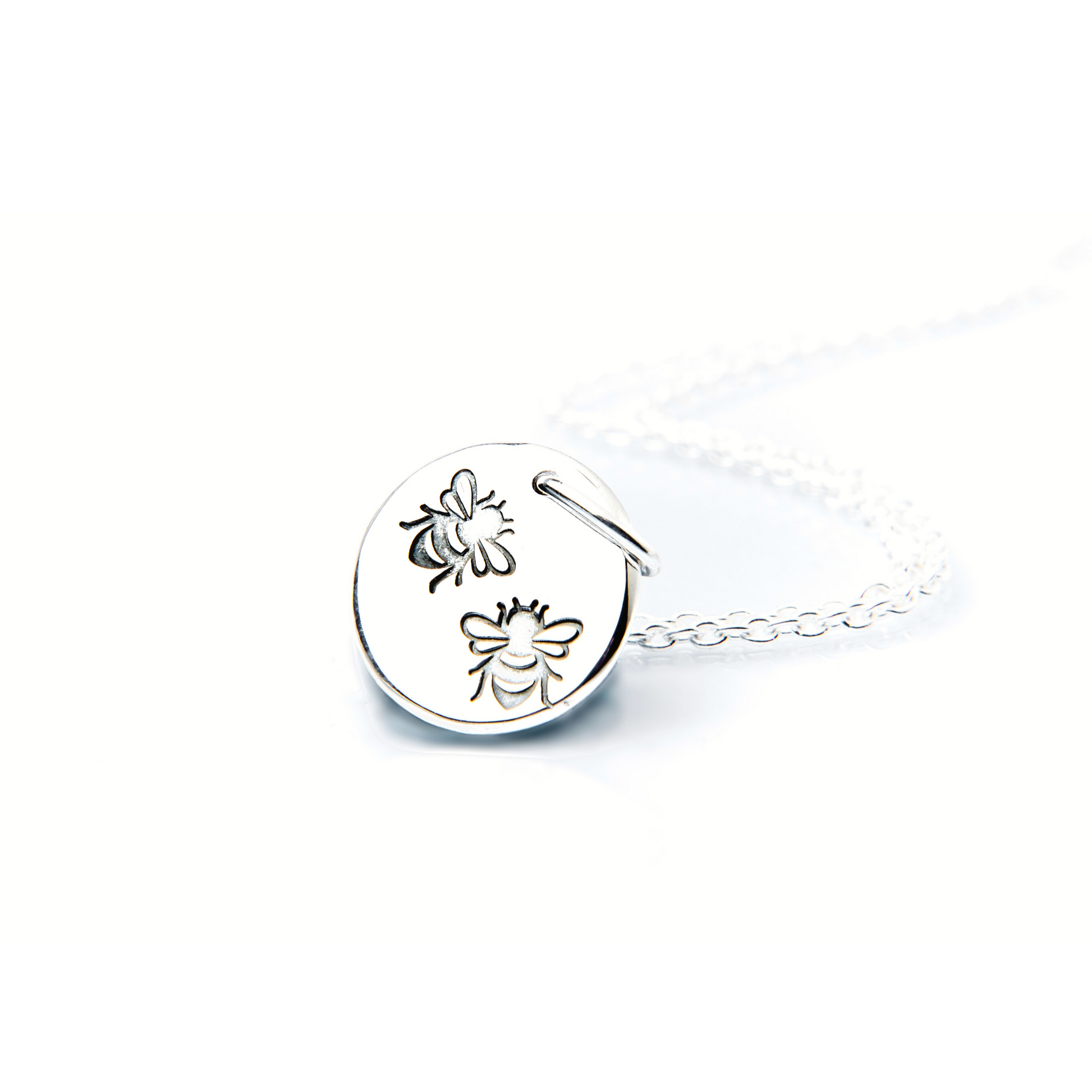 Small silver disc pendant stamped with 2 tiny bees. Complimentary sterling silver chain.