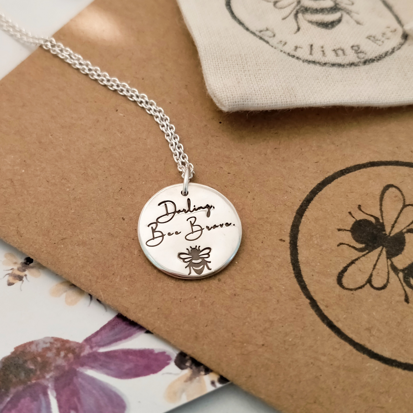 Sterling Silver circular disc pendant with motivational message; Darling, Bee Brave. Complimentary rhodium plated sterling silver chain.